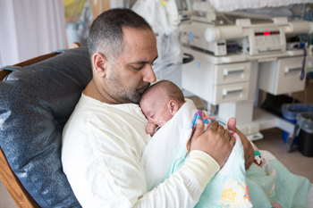 Shail, father of an NICU baby engaging in kangaroo care with her little one Shail, father of an NICU baby engaging in kangaroo care with her little one