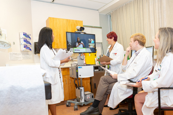 Clinicians in the Total Parenteral Nutrition clinic use telemedicine to connect with patients in remote locations Clinicians in the Total Parenteral Nutrition clinic use telemedicine to connect with patients in remote locations