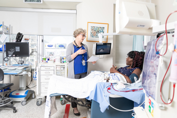 Alison Thomas speaking to hemodialysis patient Paulette Caine