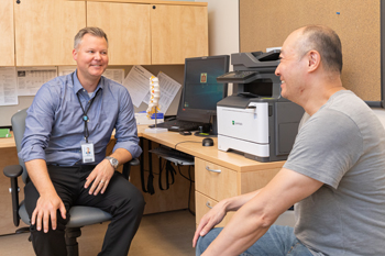 Dr. Andrew Bigness discusses how to manage lower back pain with patient Neng Li Dr. Andrew Bigness discusses how to manage lower back pain with patient Neng Li