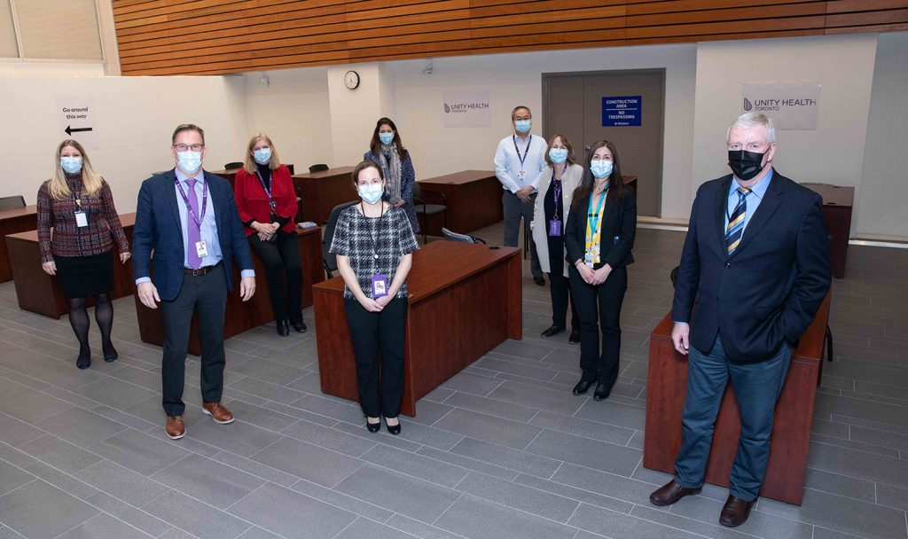 General Rick Hillier (right) alongside Unity Health Toronto executives and staff. (Photo: Katie Cooper, Medical Media Centre)