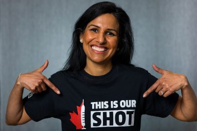 Dr. Anju Anand points to a t-shirt with the slogan, "this is our shot".