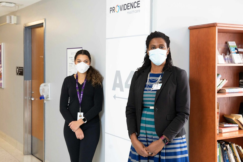 Julia Thompson and Lori Brady stand at the entrance to Providence Healthcare's A4 wing.