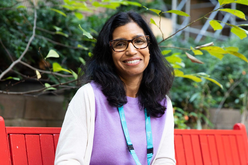 Dr. Srivastava sits on a park bench.