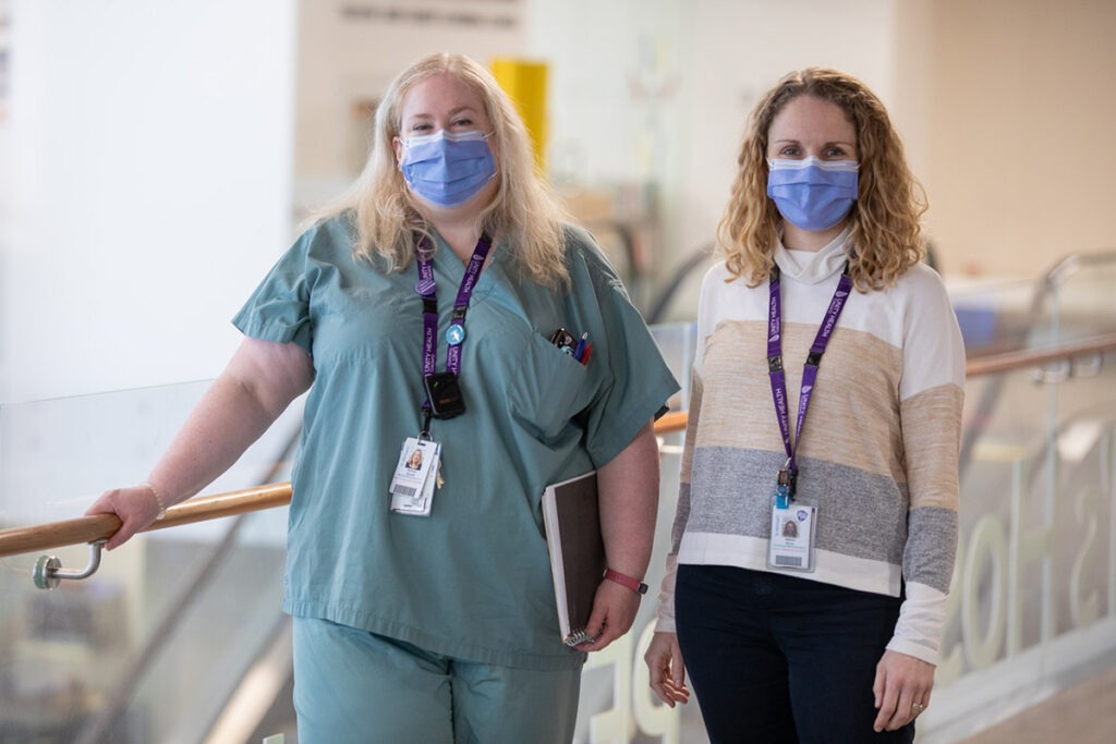 Dorinda Sinott and Allison Rinner stand in the Peter Gilgan Patient Care Tower at St. Michael's Hospital.