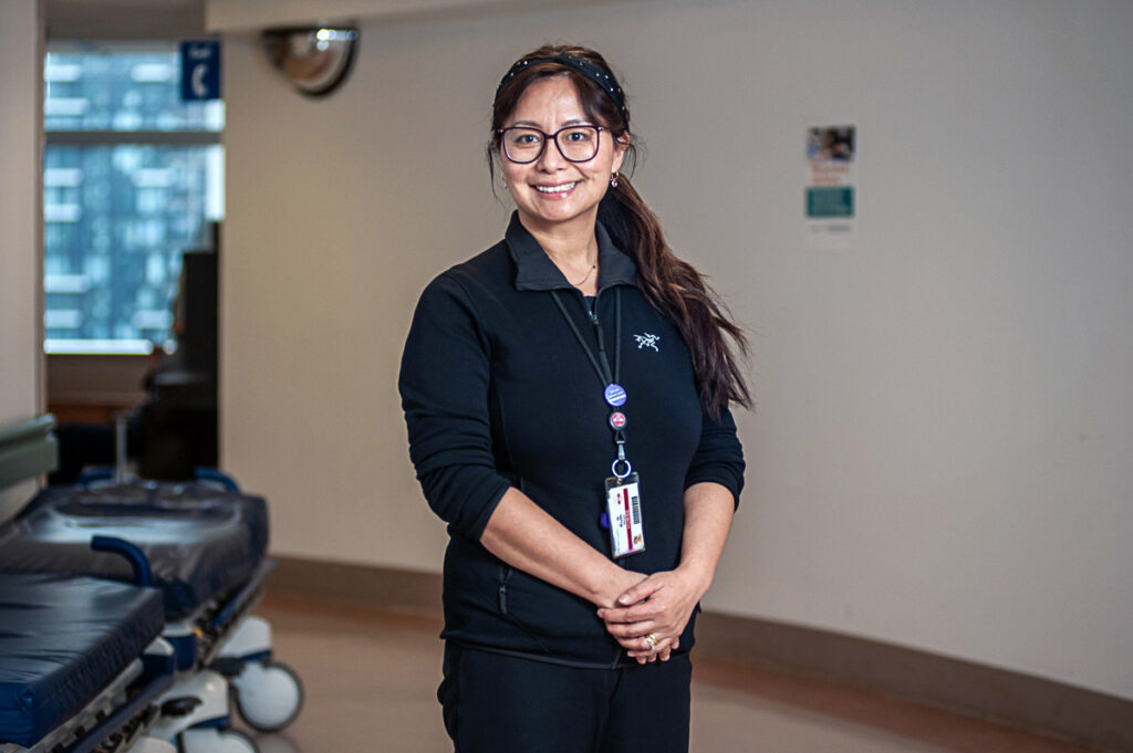 Ruth Mega stands in the hallway of St. Michael's 16CCN unit.