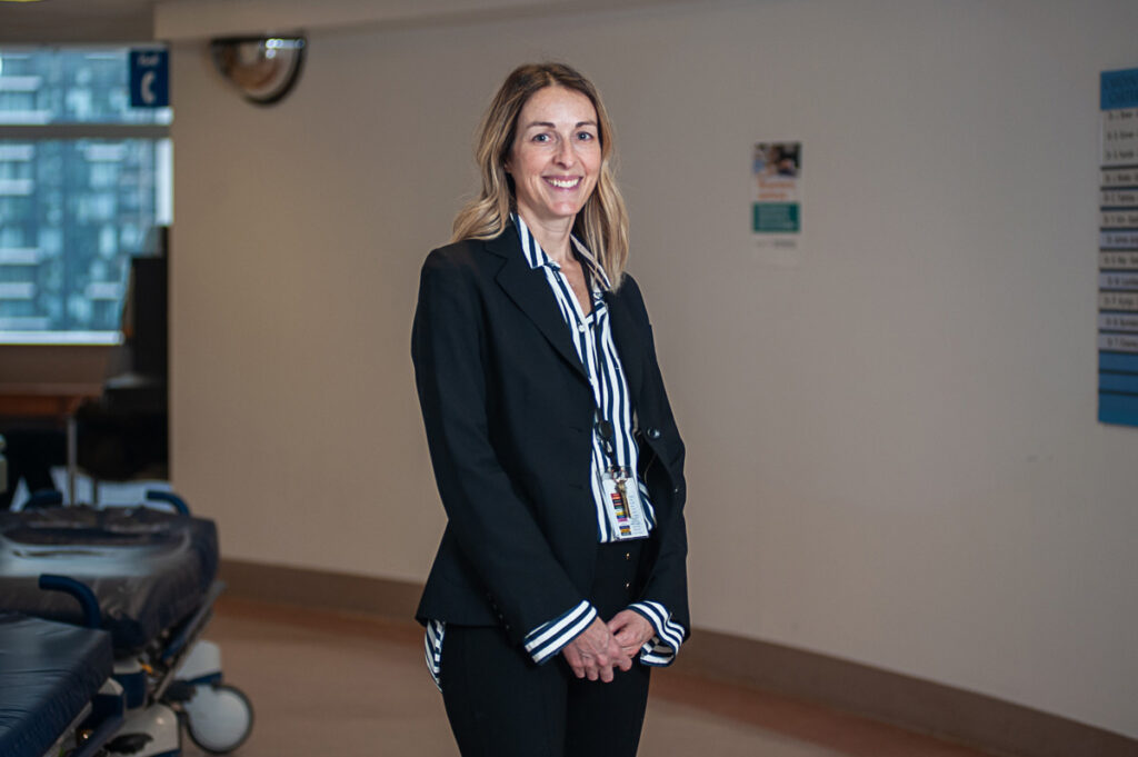 Swanee Tobin stands in the hallway of St. Michael's 16CCN unit.