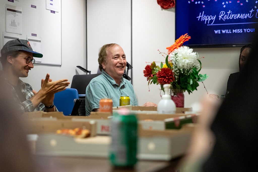Gord Singer sits at a conference room table and smiles.