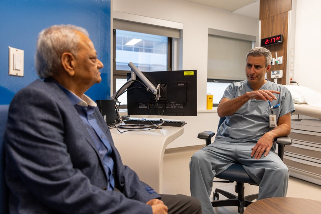 Dr. Neil Fam speaks with his patient, Mir Hasan Ali.